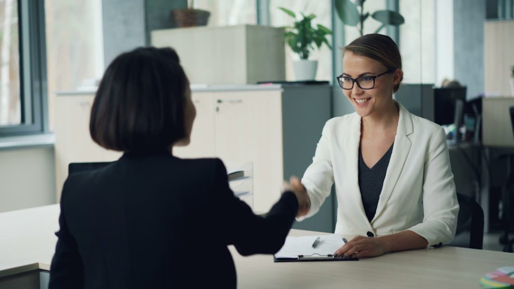 Business partners shaking hands in office